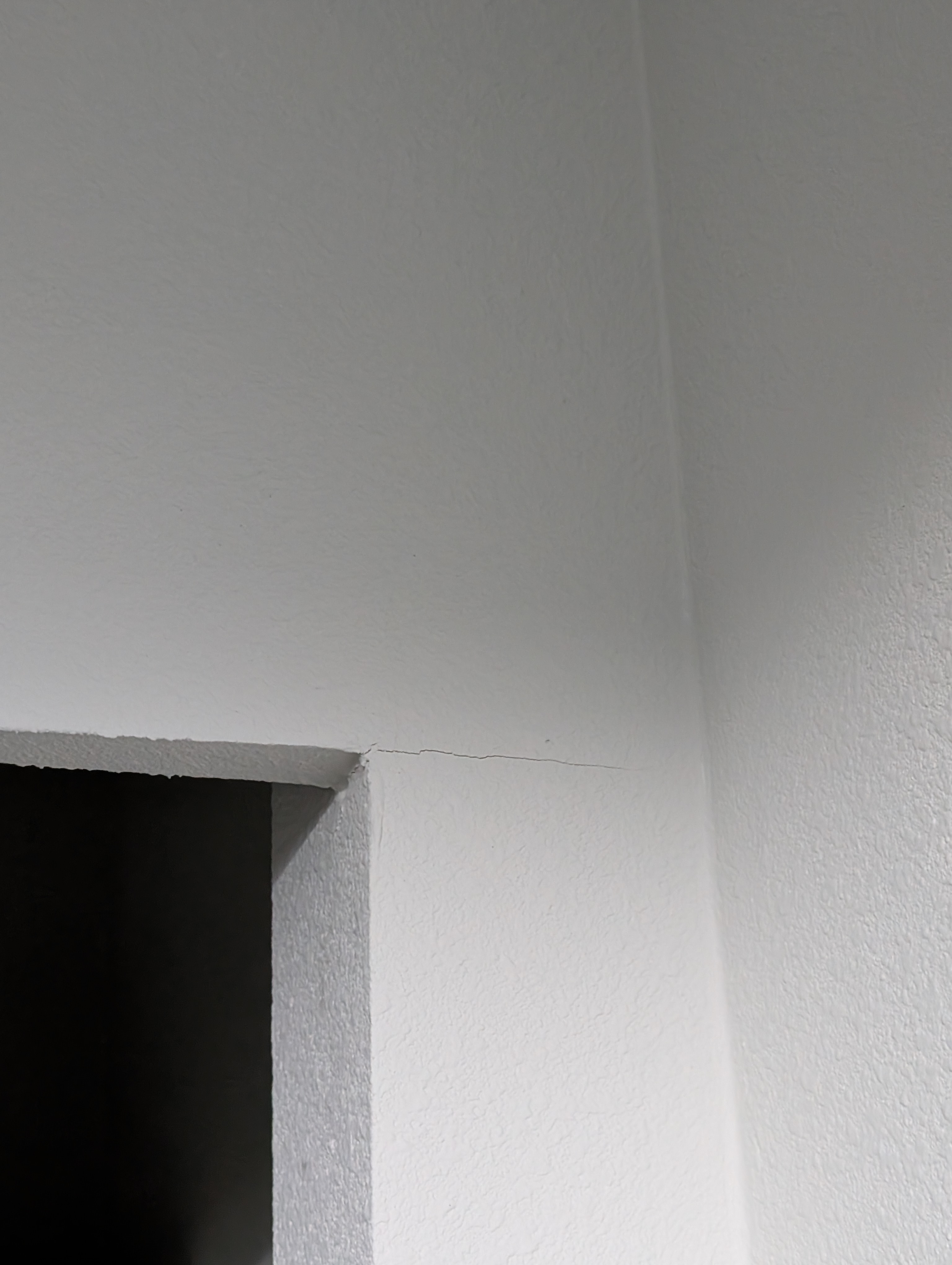 A close-up view shows a fine hairline crack along the wall plane in the master bedroom.