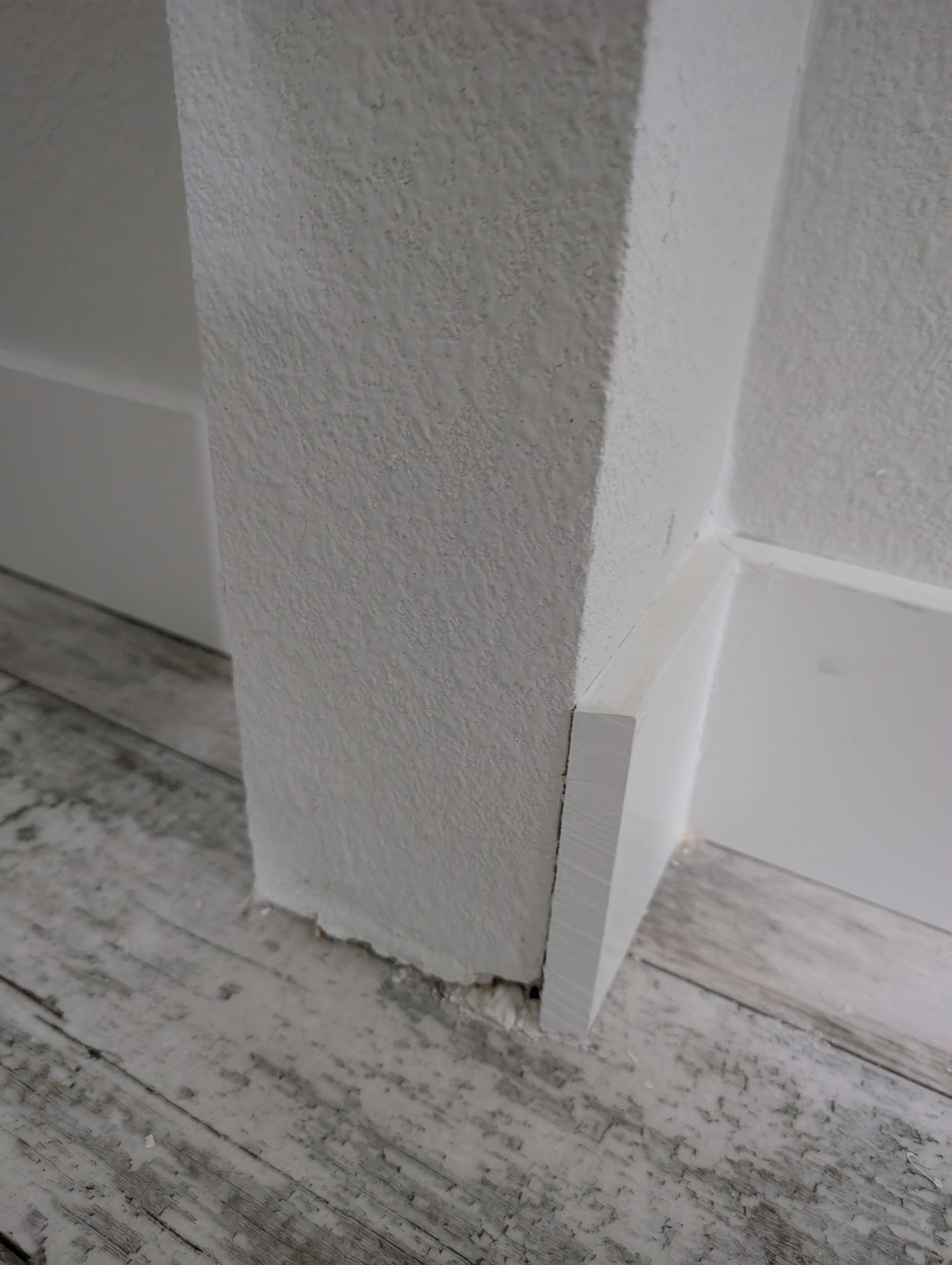 Multiple hairline cracks are visible forming a subtle pattern on the master bedroom wall.