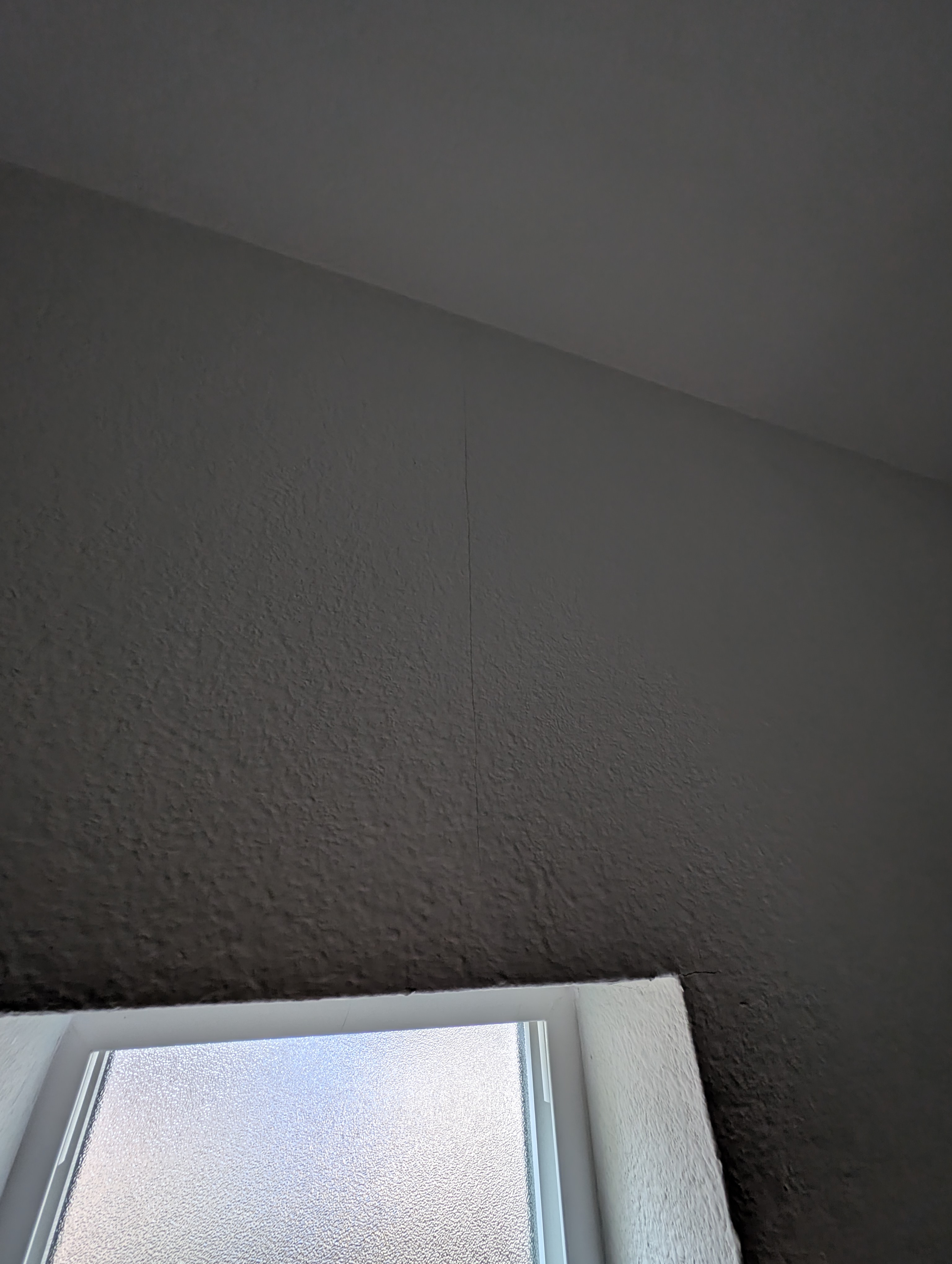 A hairline wall crack is visible under low lighting conditions in the bedroom adjacent to the master bedroom.