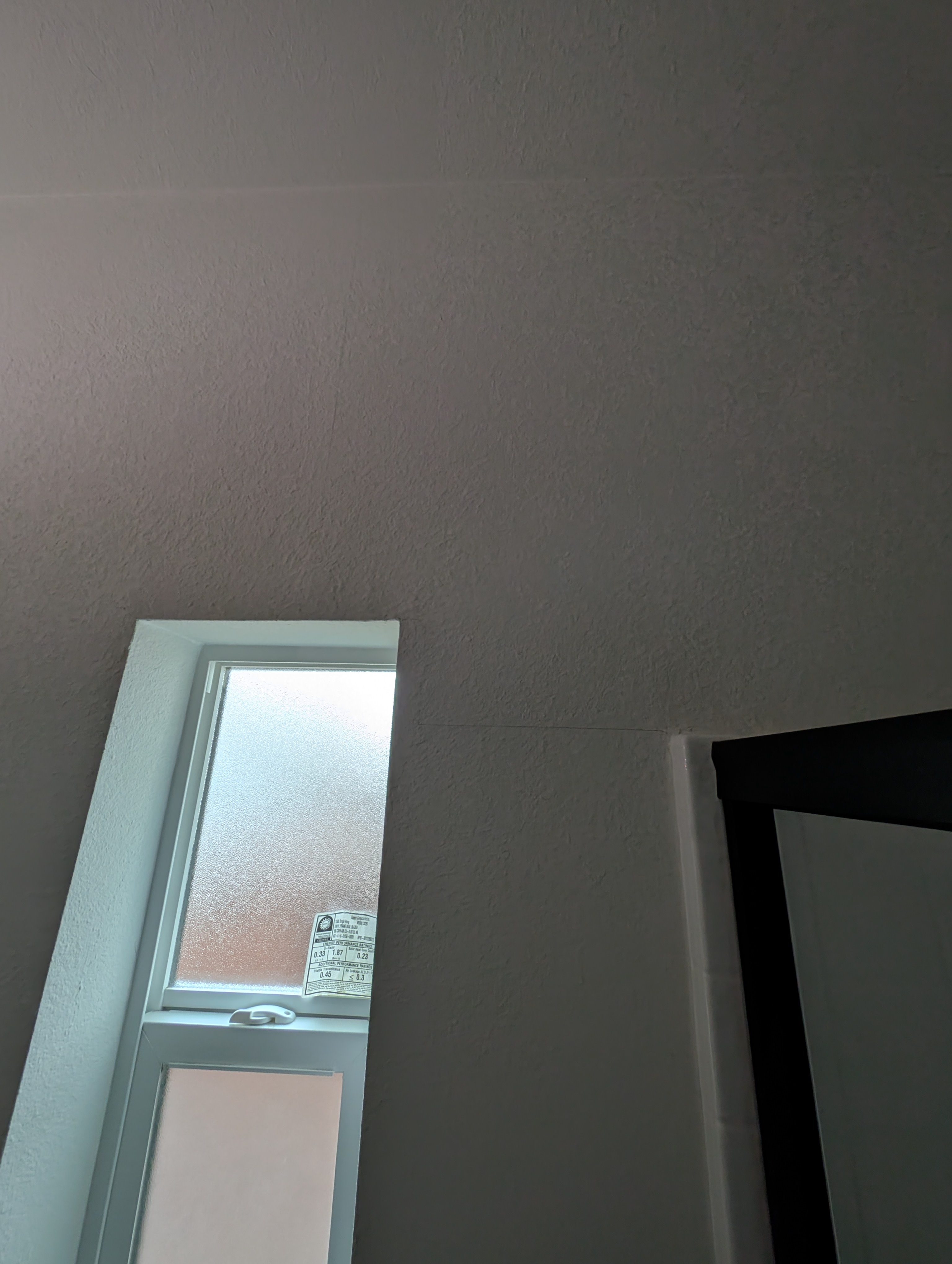 A vertical crack extends along the wall surface in the bedroom adjacent to the master bedroom.