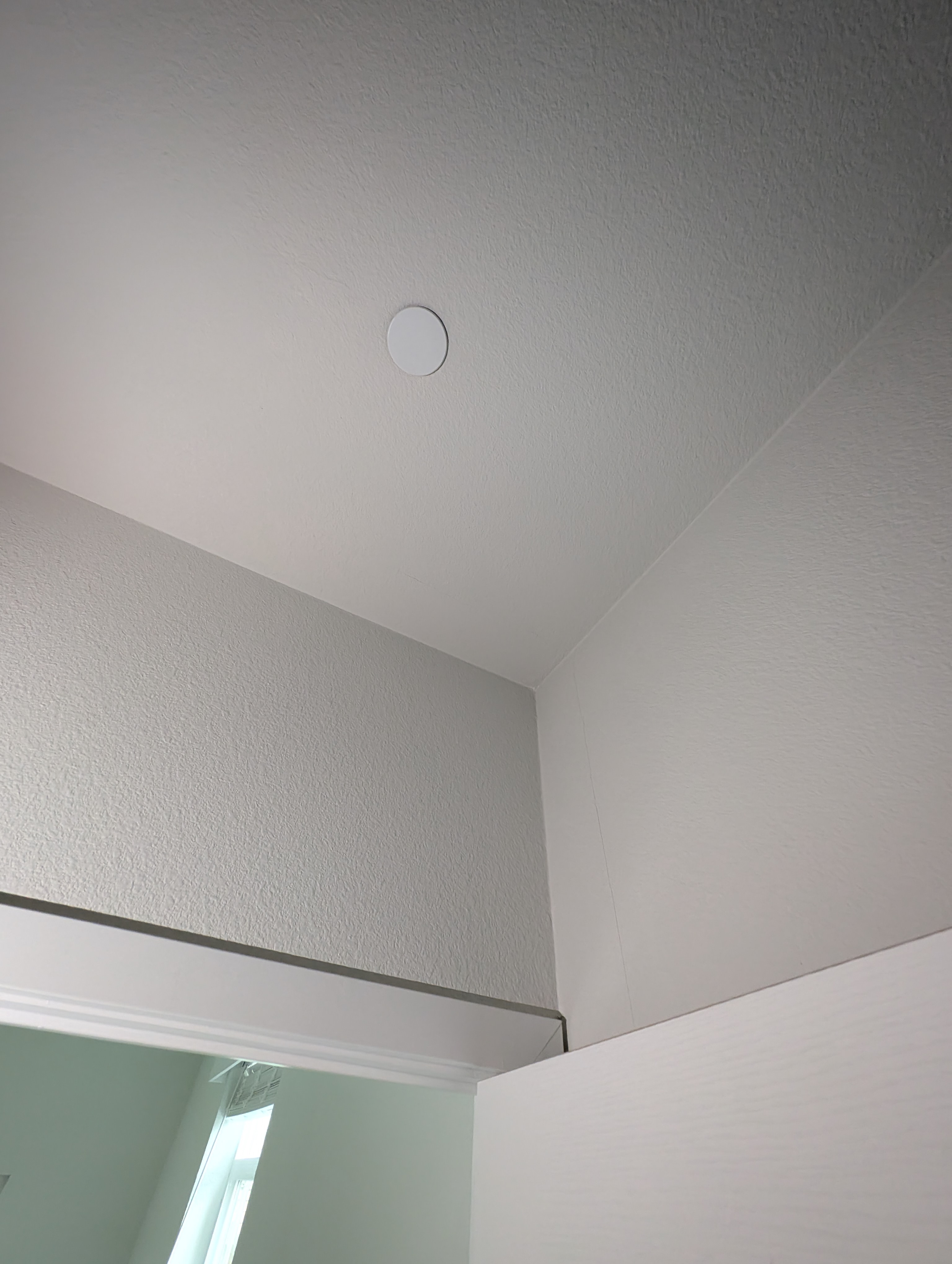 A vertical wall crack is visible in the living room under night lighting.