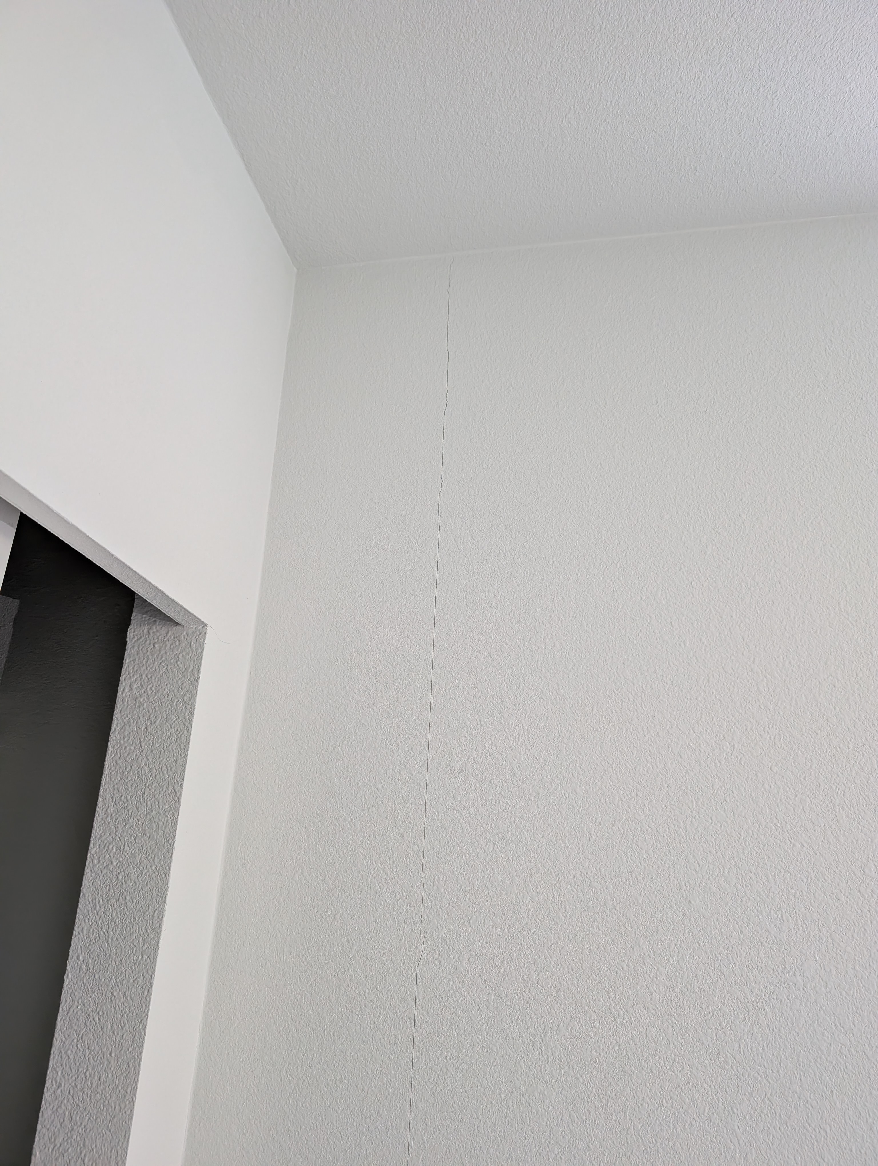 A vertical hairline crack runs down the wall surface in Bathroom 2.