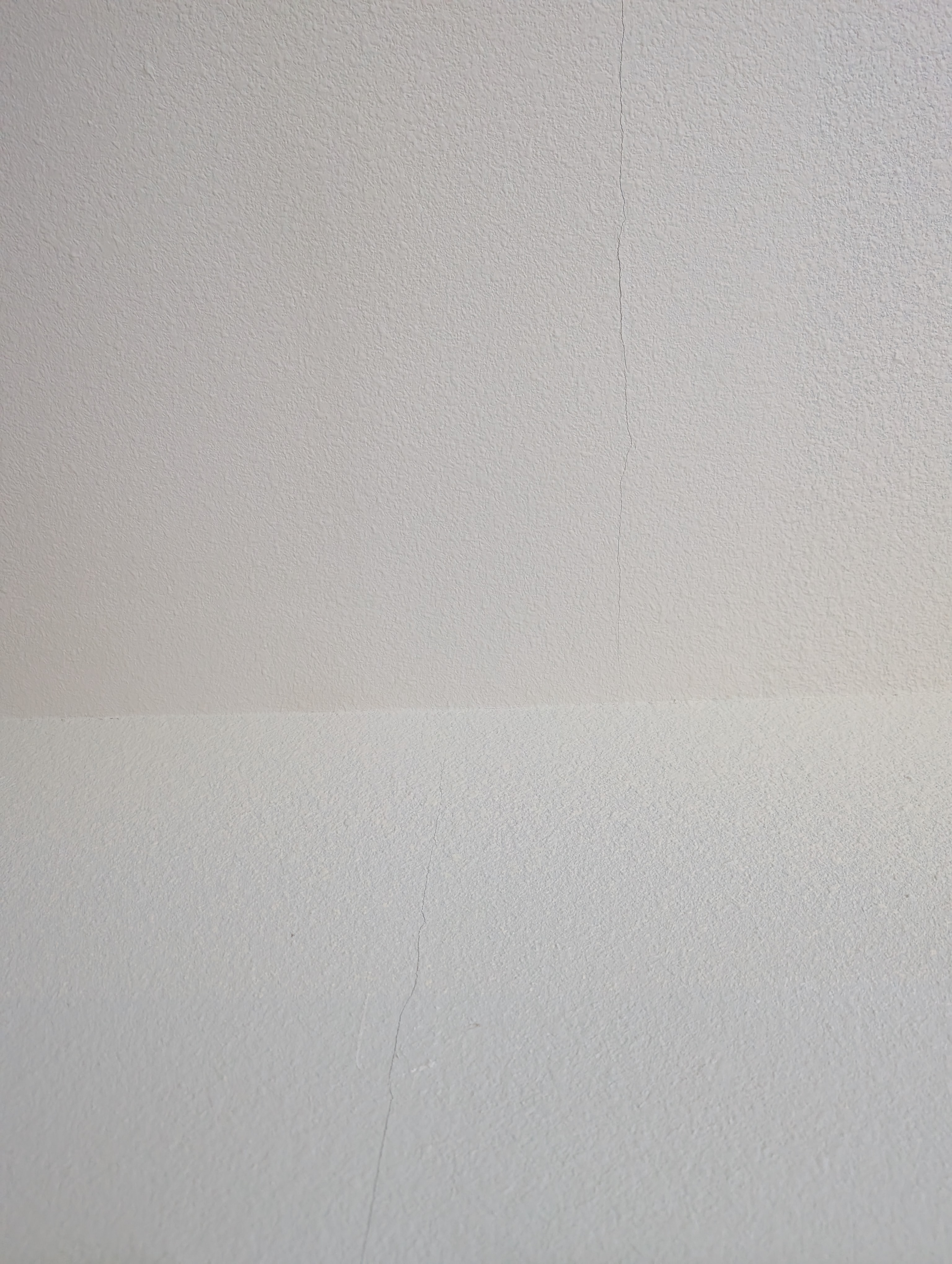 A crack is visible at the wall and ceiling junction in the master bedroom.