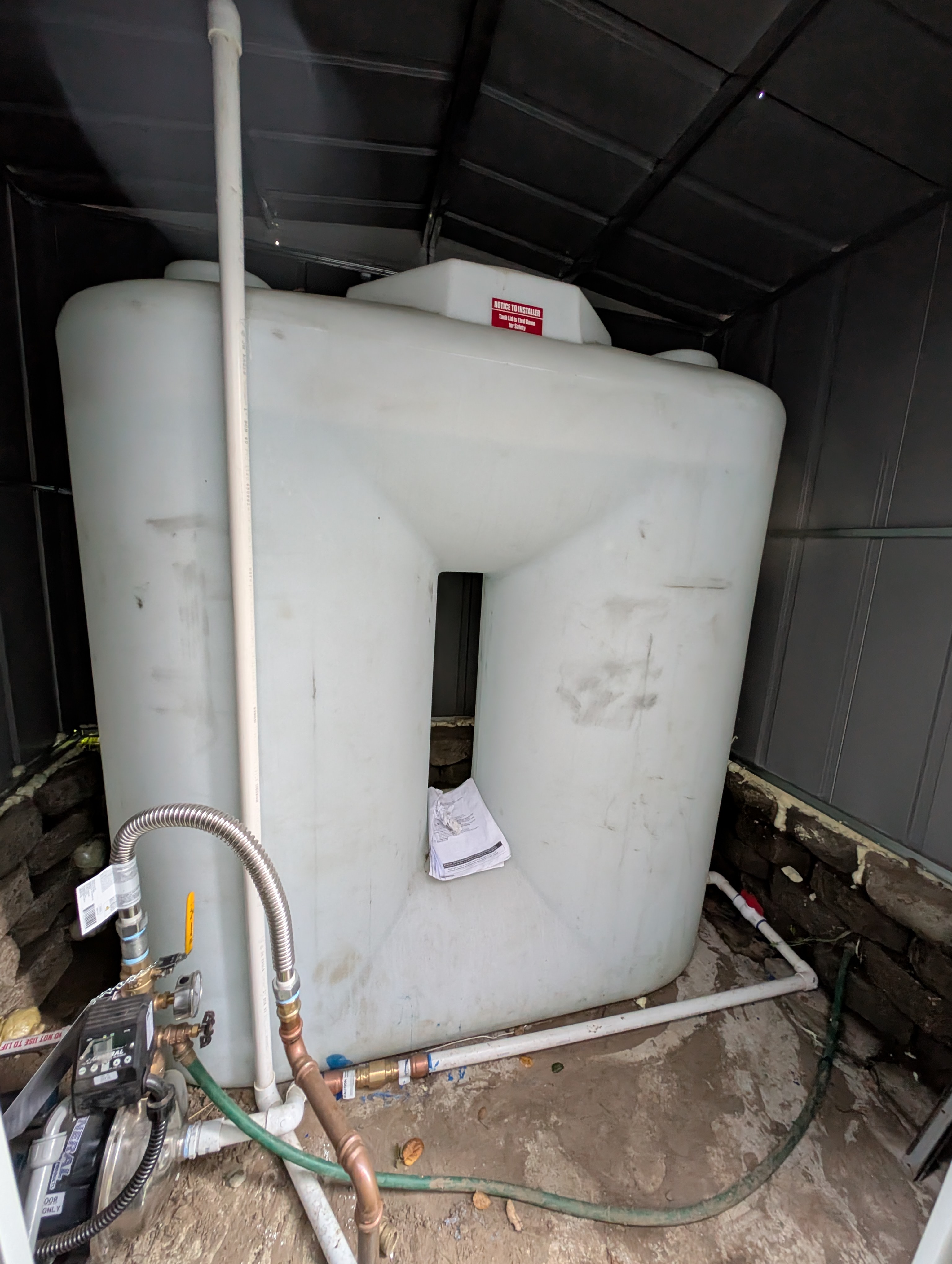 The water heater access door was not latched or closed, reflecting improper handling or incomplete work.