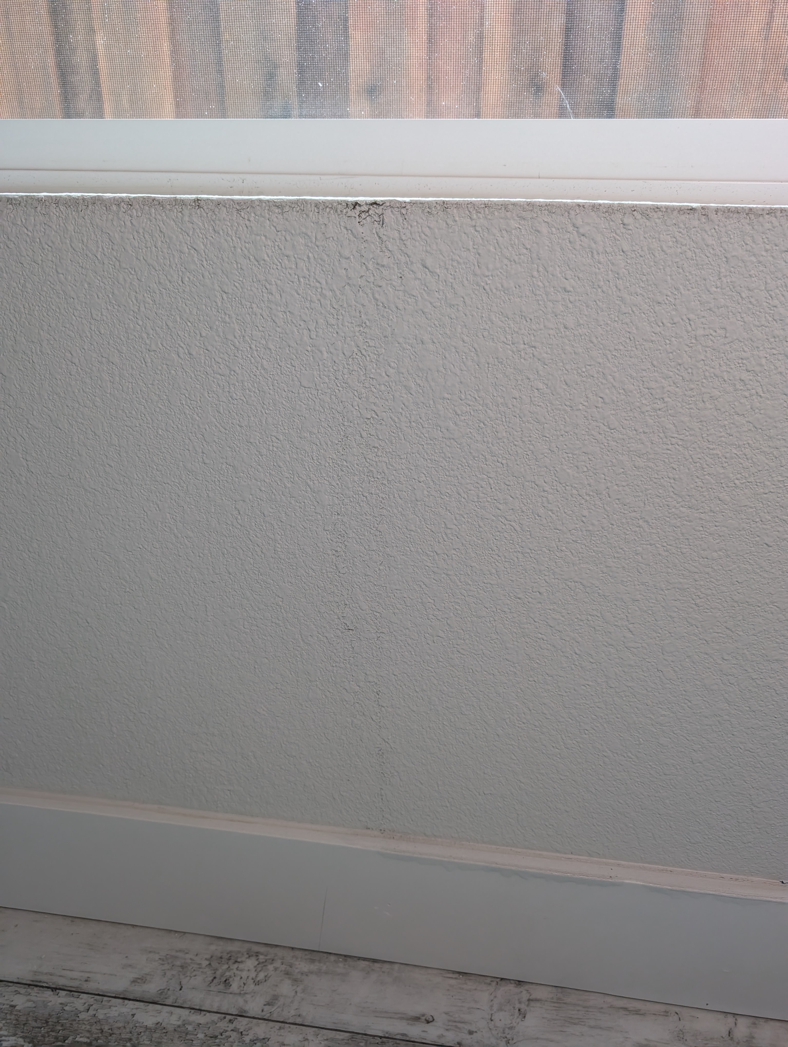 Water damage visible beneath window (night photo)