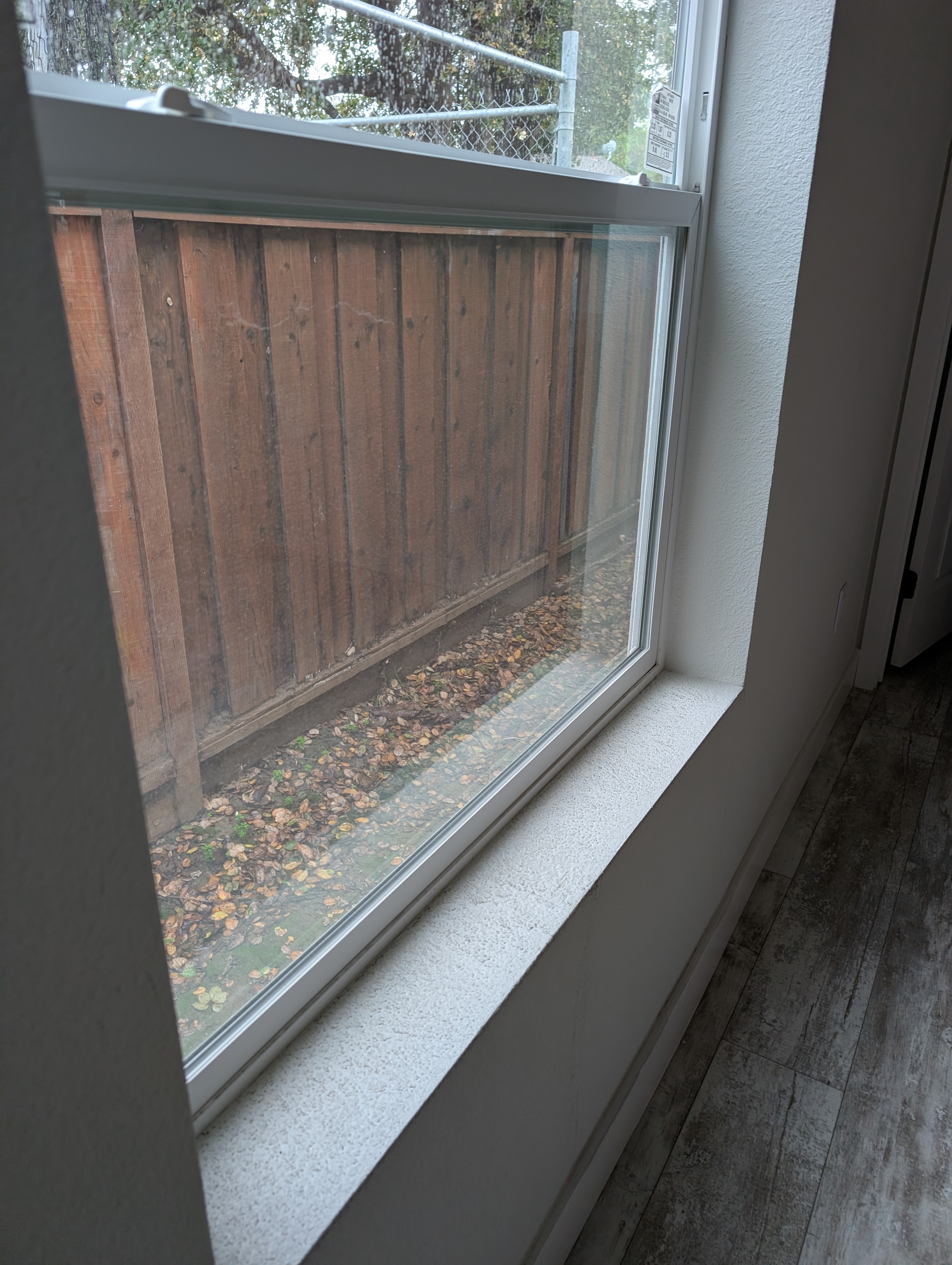 Close-up of water damage on wall beneath window